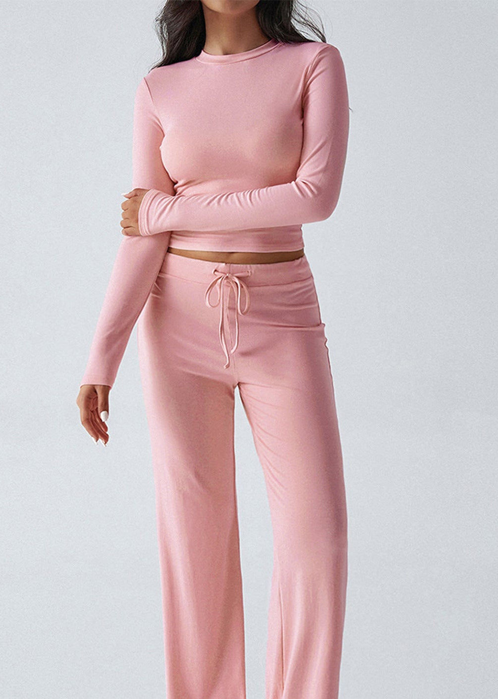 Pink cropped long-sleeve top and matching wide-leg sweatpants set with drawstring