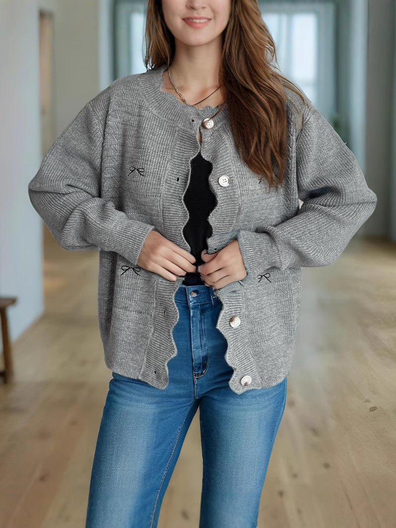 Gray knit cardigan sweater with bow embroidery and button front, oversized fit