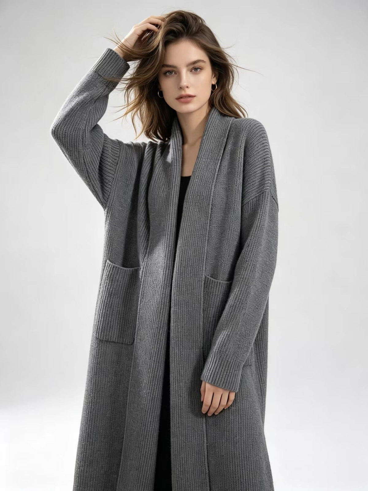 Gray knitted cardigan sweater jacket with open front, long sleeves, and patch pockets