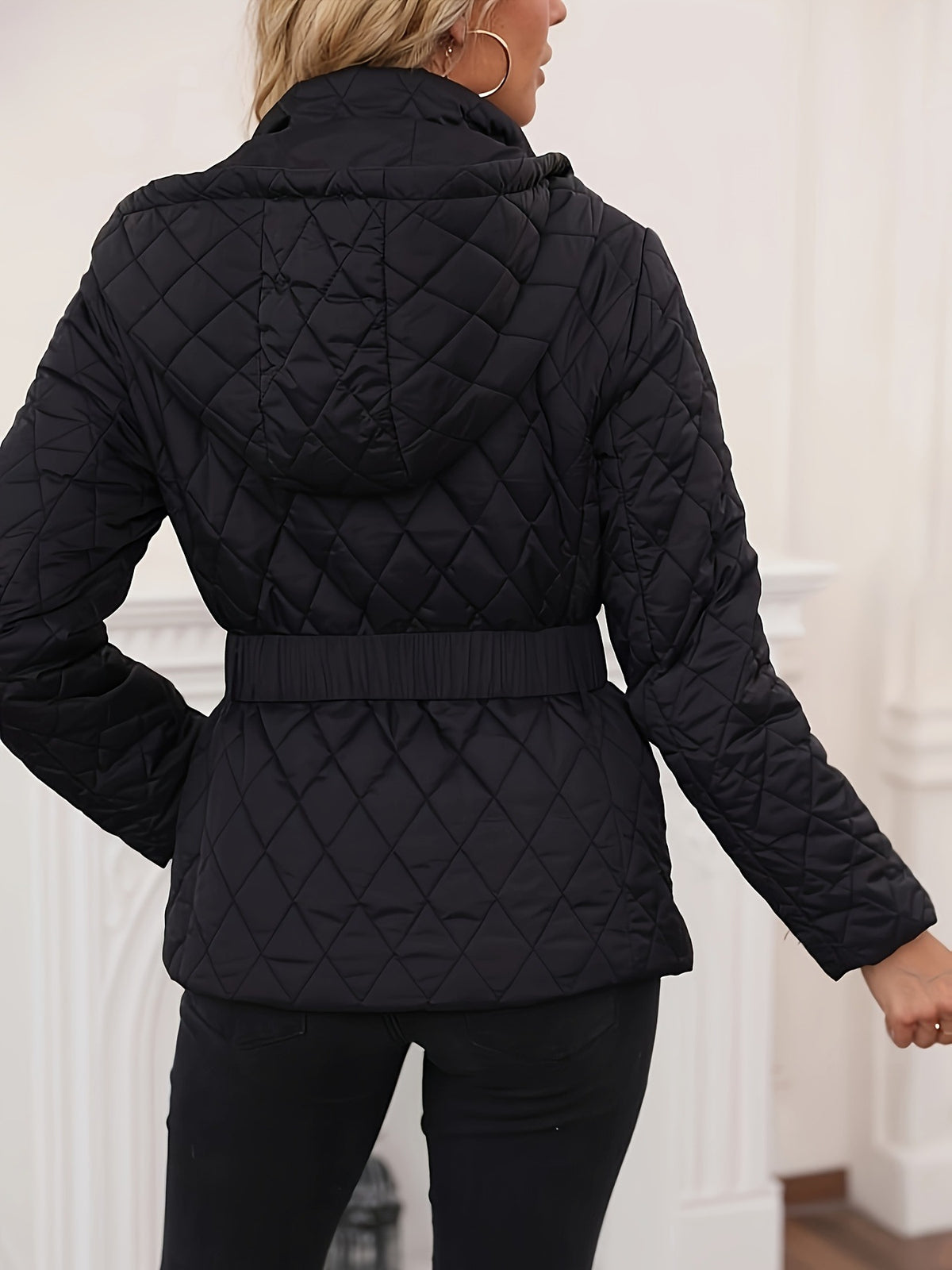 Black quilted diamond-pattern hooded jacket with full zip and belted waist
