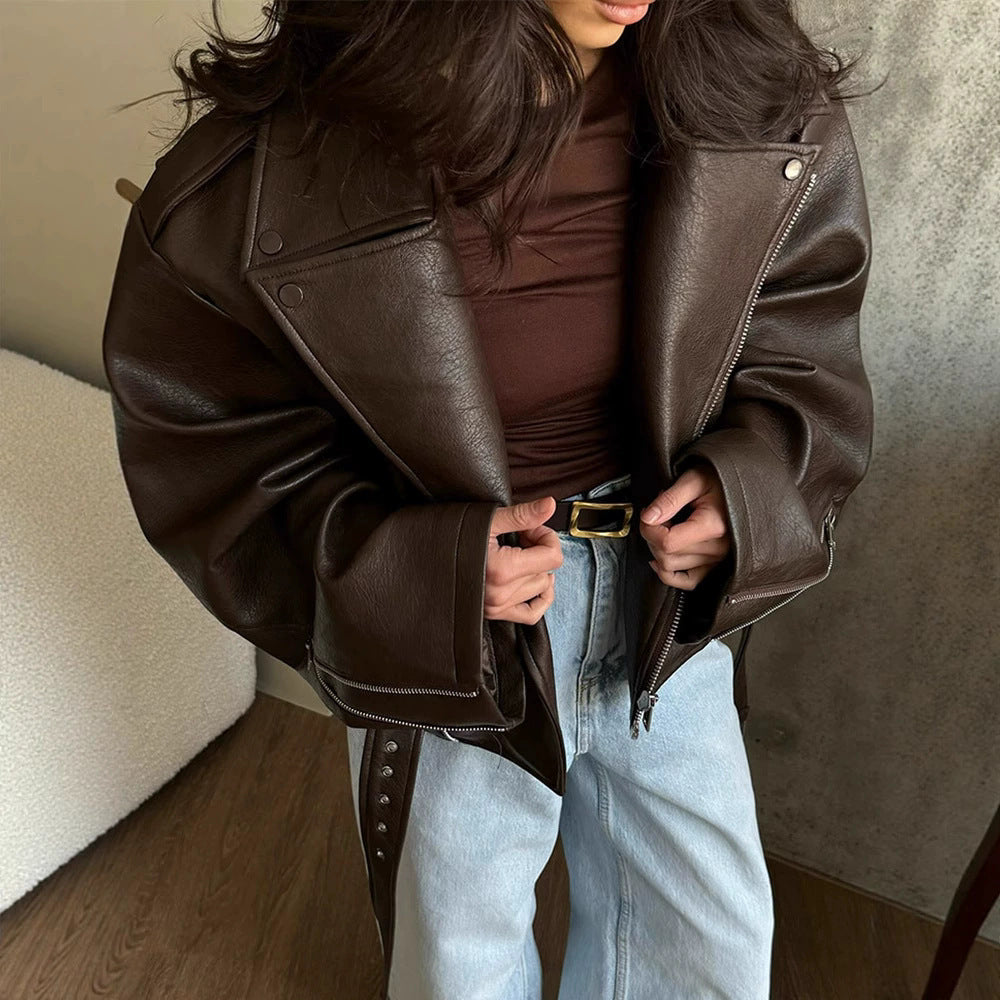 Women's brown leather motorcycle jacket, diagonal zip, metal studs, belt tie at waist