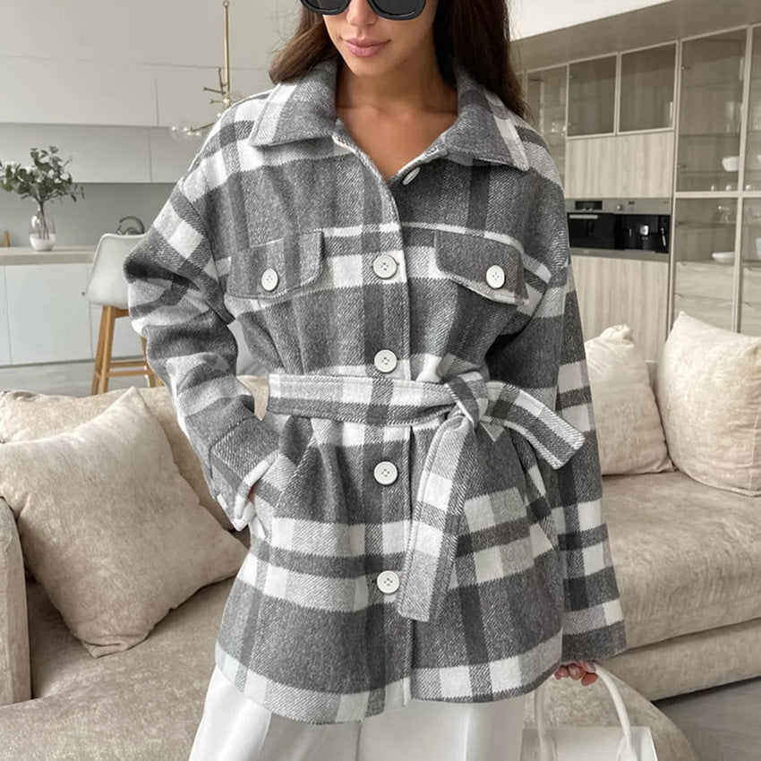 Gray and white plaid coat with lapels, buttoned pockets, and a waist tie belt