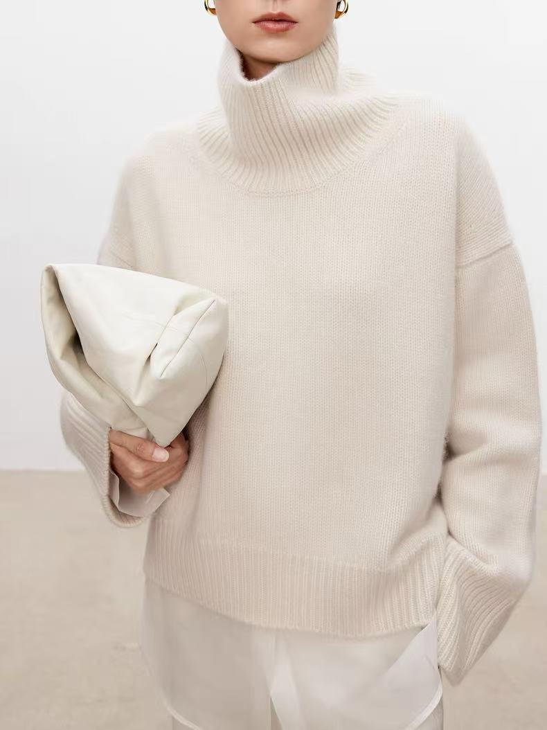 Cream knitted turtleneck sweater with long loose sleeves and ribbed cuffs