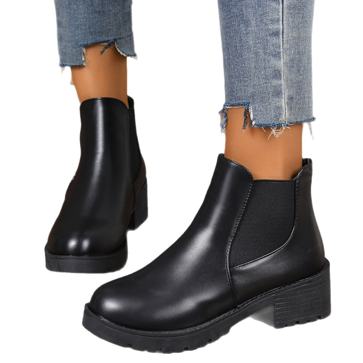 Black Chelsea boots with rounded toe, elastic side panels, and thick tread block heel