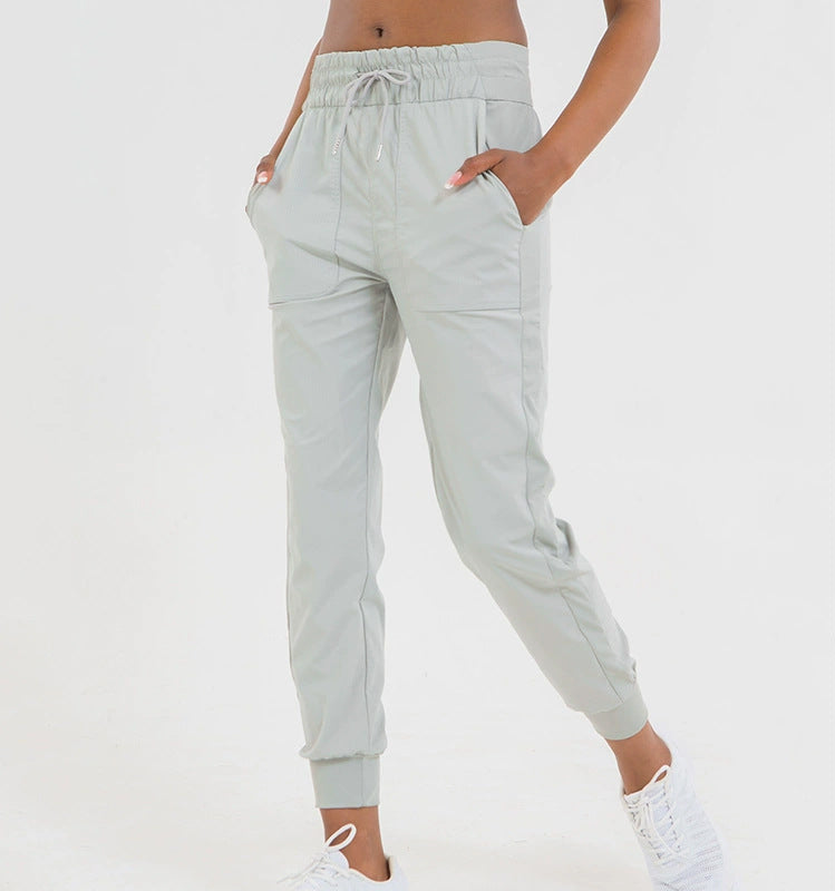Light green jogger pants with drawstring waist and ankle cuffs, side pockets