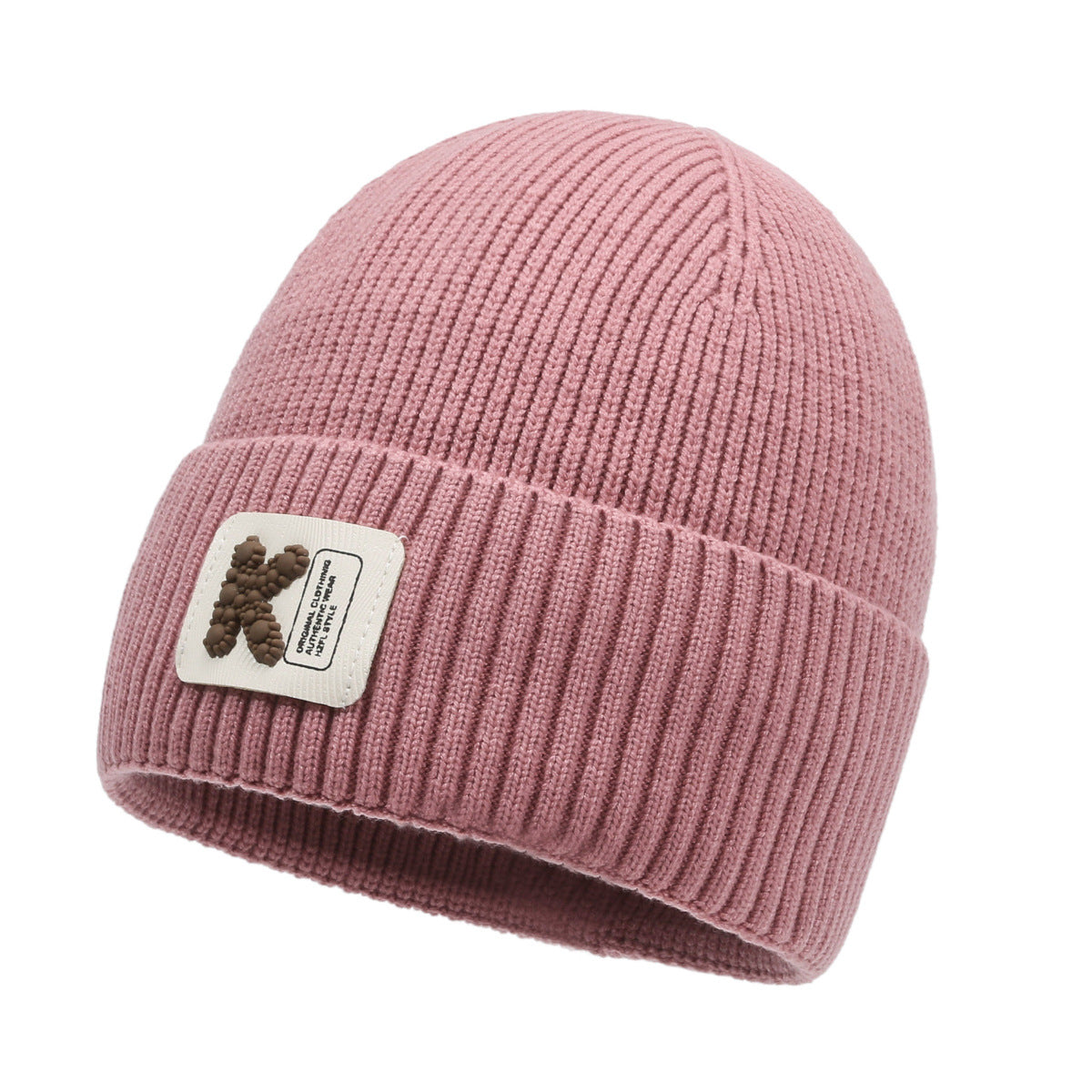 Pink rib-knit beanie hat with pom-pom style patch on cuff