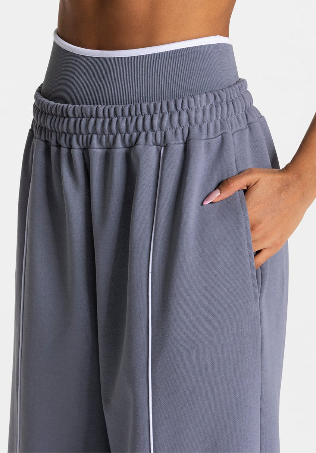 Light gray-blue loose yoga pants with elastic waistband and vertical side stripe detail.