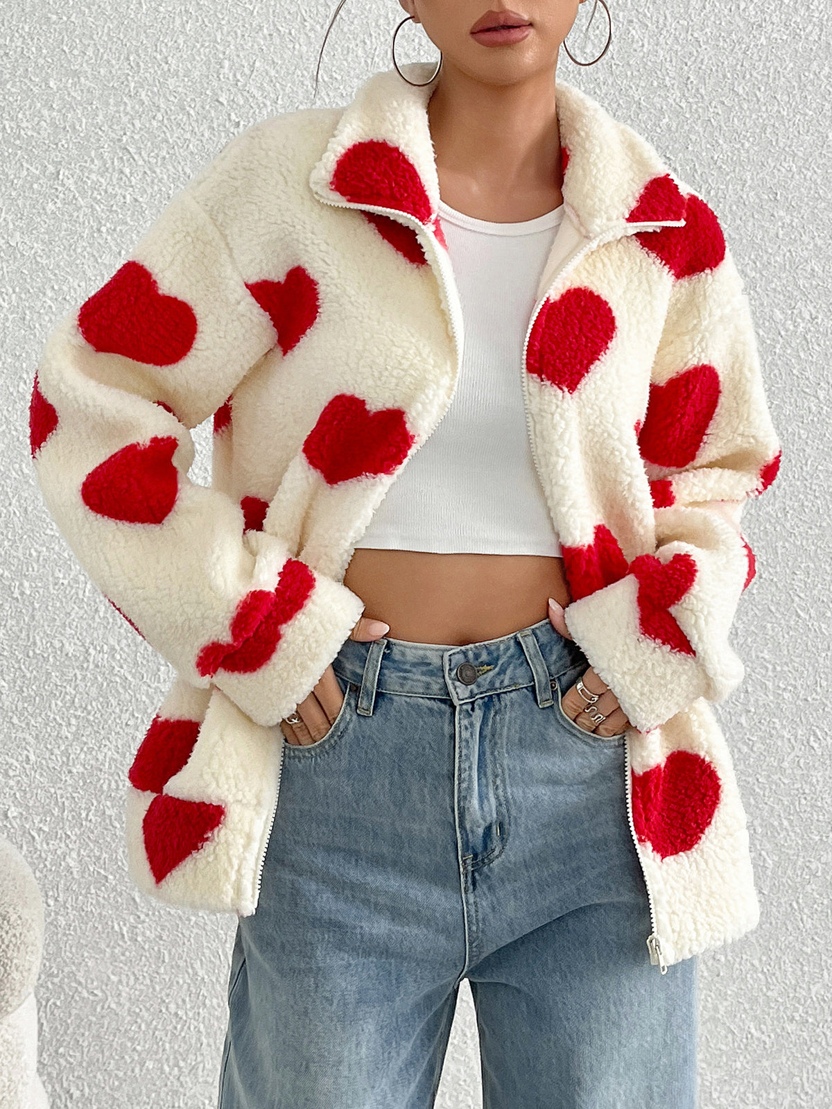 Cream plush zip-up cardigan with red hearts, long sleeves, open collar over white top