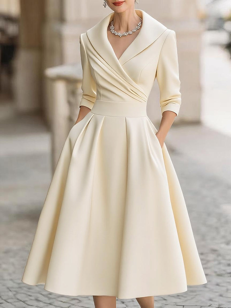 Women’s waist-cinching dress, cream, long sleeves, V-neck, flared A-line silhouette.