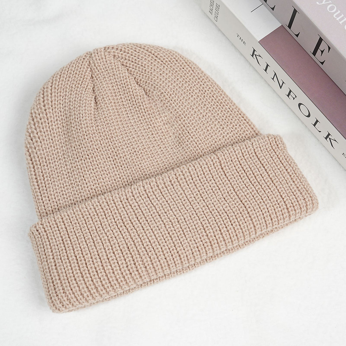 Light beige thick ribbed knit beanie hat with folded cuff.