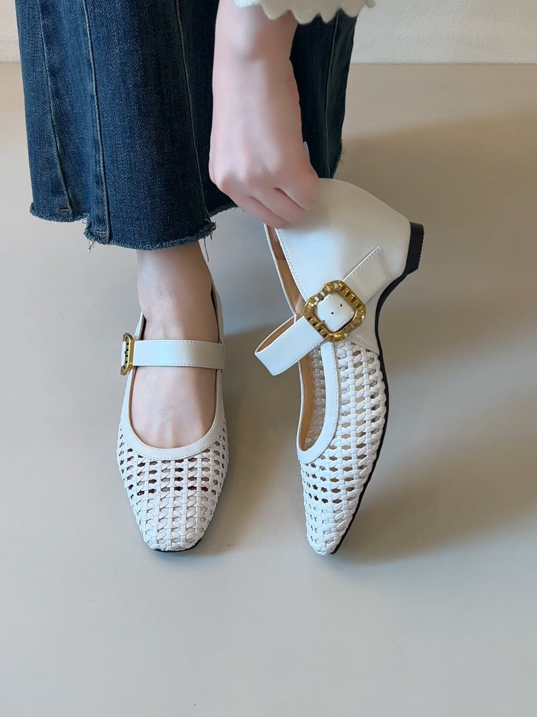 Off-white woven Mary Jane heels with single strap and gold buckle, square toe