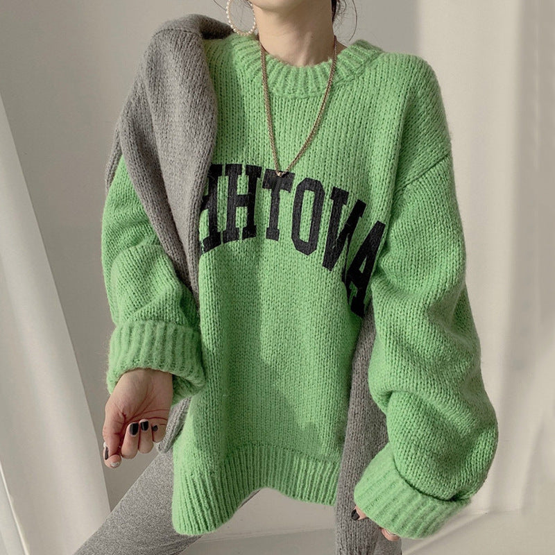 Neon green chunky knit crewneck sweater with black slogan graphic