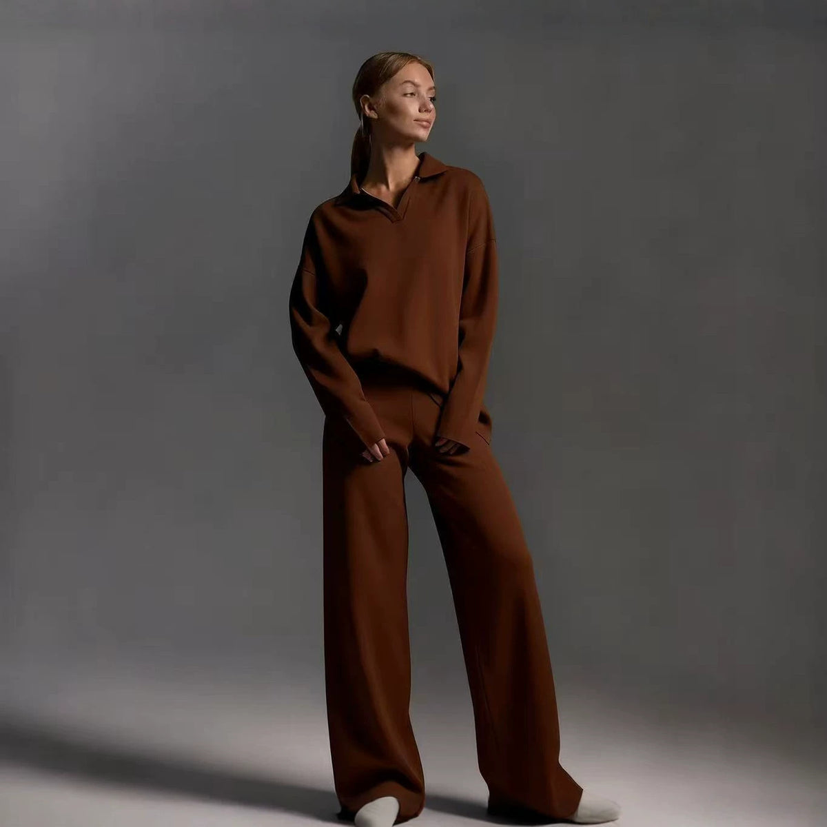 Brown women's polo-neck two-piece set with wide-leg pants, relaxed stance