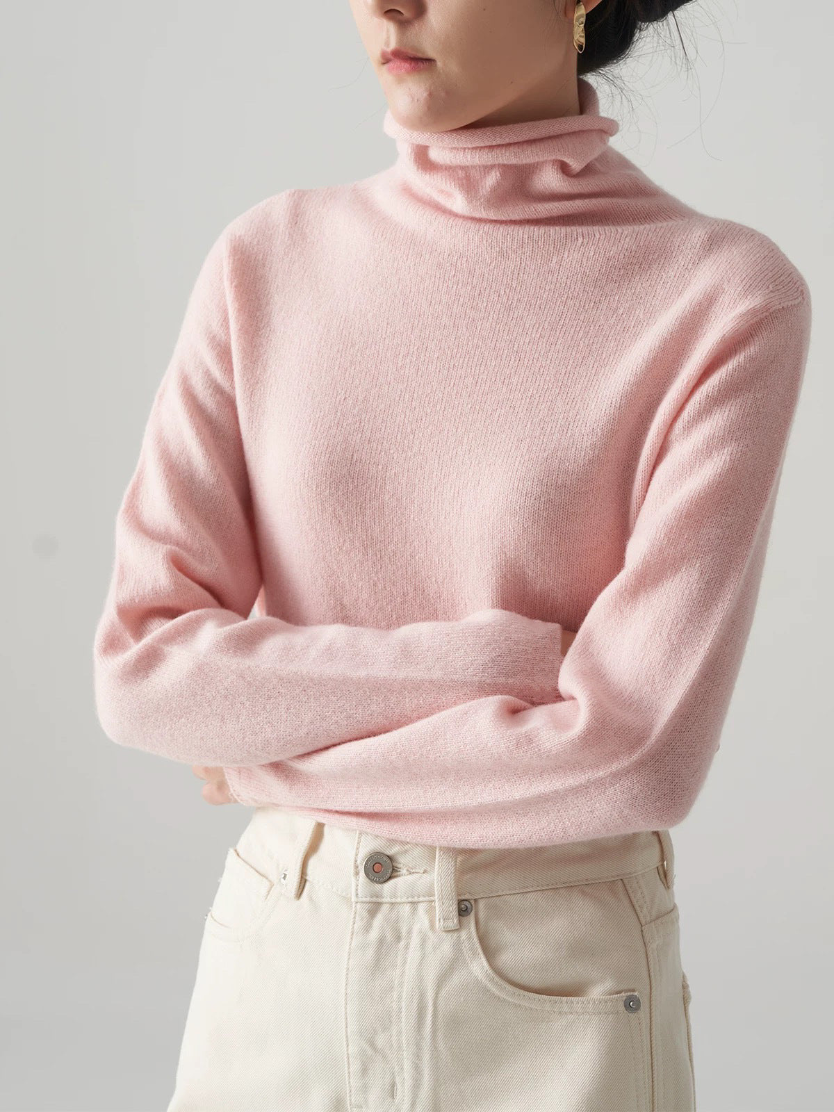 Pink knit turtleneck sweater with stack collar and long sleeves
