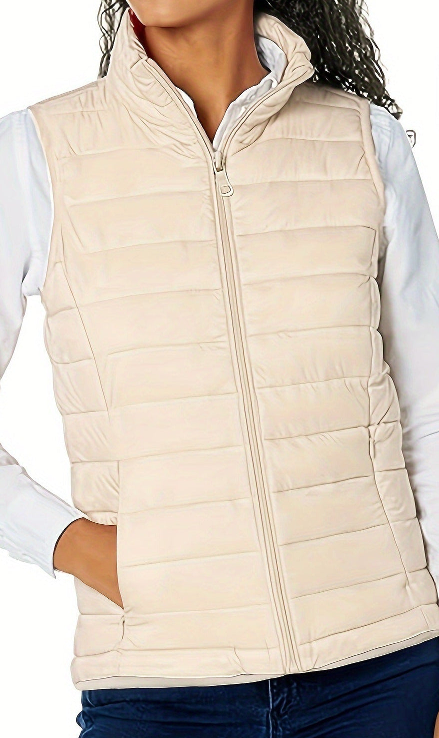 Off-white sleeveless puffer vest with stand collar, zip front, and quilted panels
