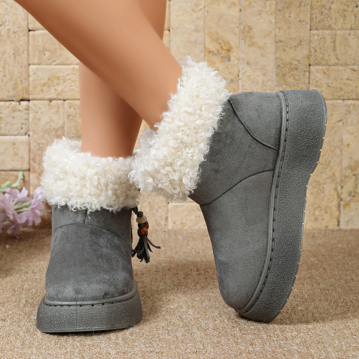 Gray suede ankle boots with white faux-fur cuffs and tassel charm detail