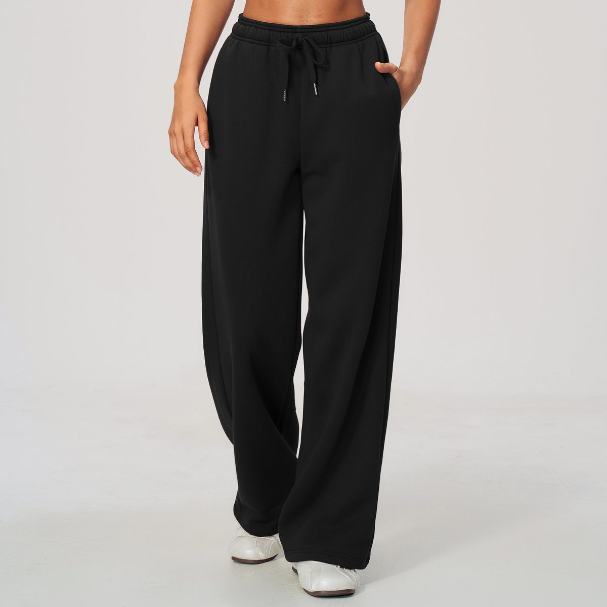 Black high-waisted sweatpants with elastic waistband, drawstring, relaxed wide-leg fit