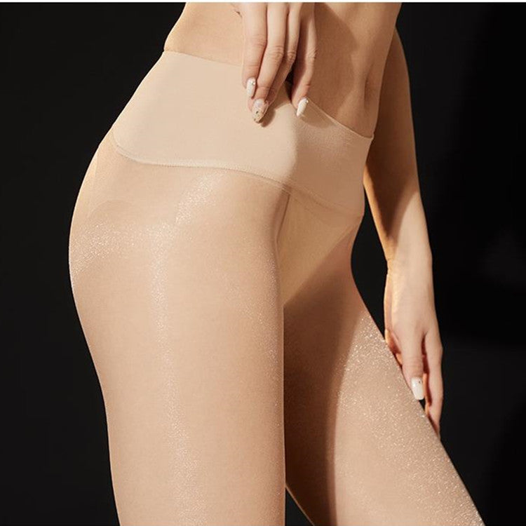 Side view of sheer skin-tone pantyhose with a wide beige waistband.