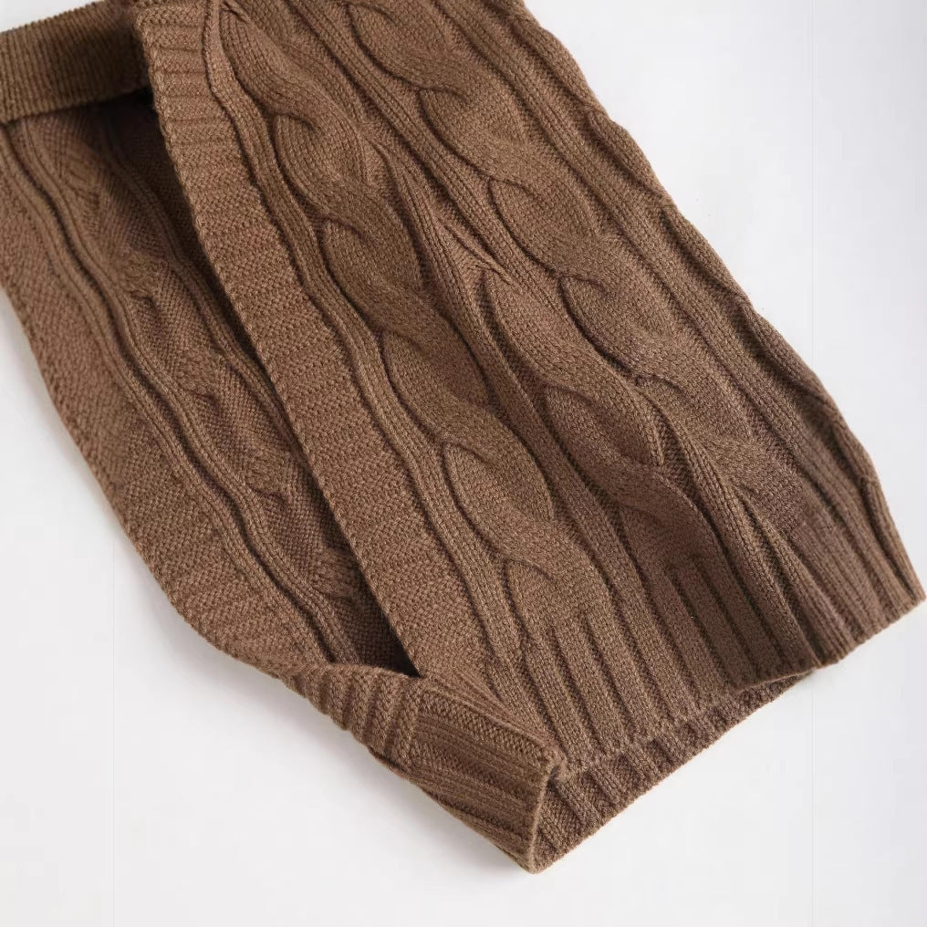 Brown cable and rib knit fabric detail on sweater sleeve and hem