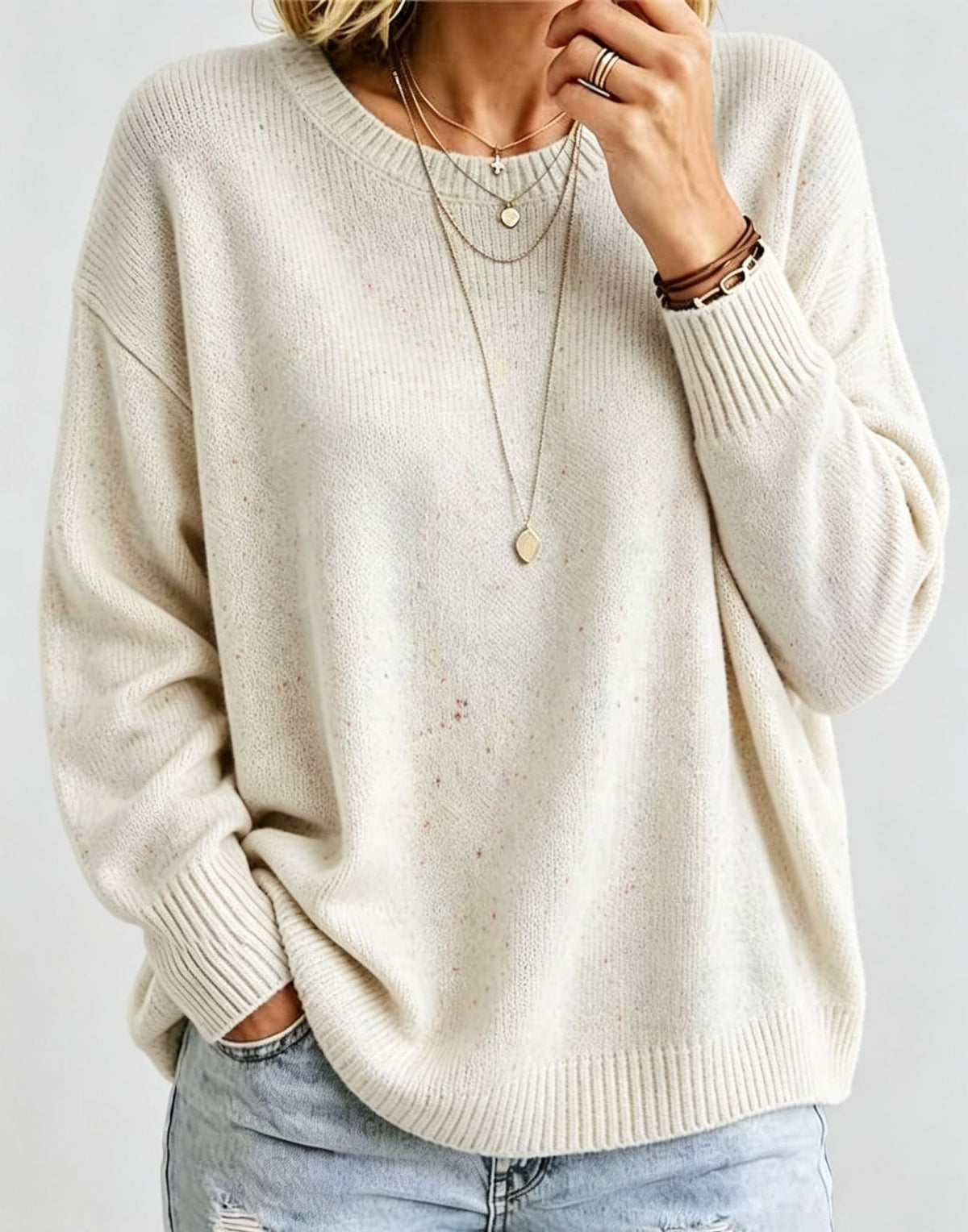 Cream cropped knit pullover with crew neck and ribbed cuffs, oversized fit