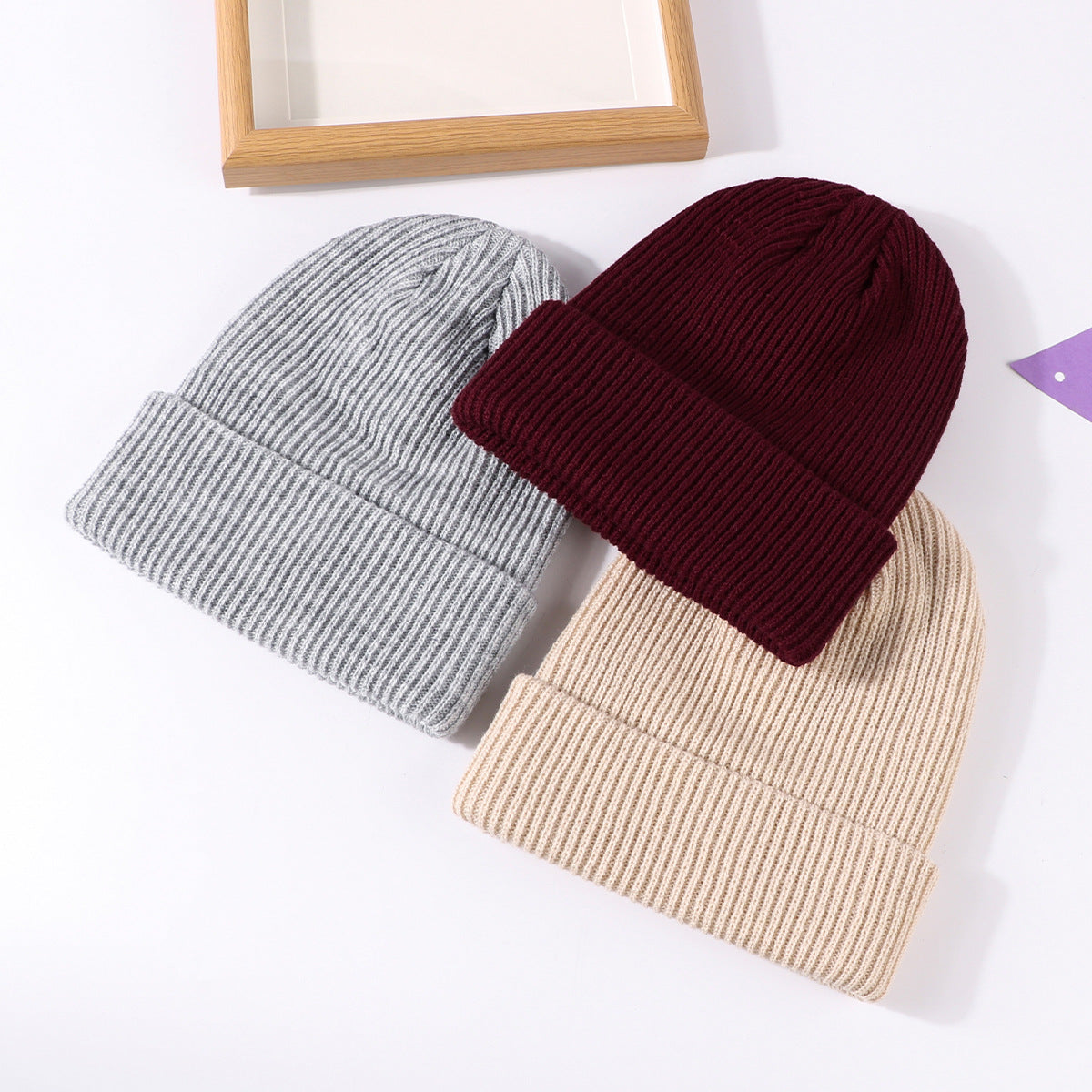 Knit beanie hats set: heather gray, burgundy, and beige with fold-up cuff and logo patch