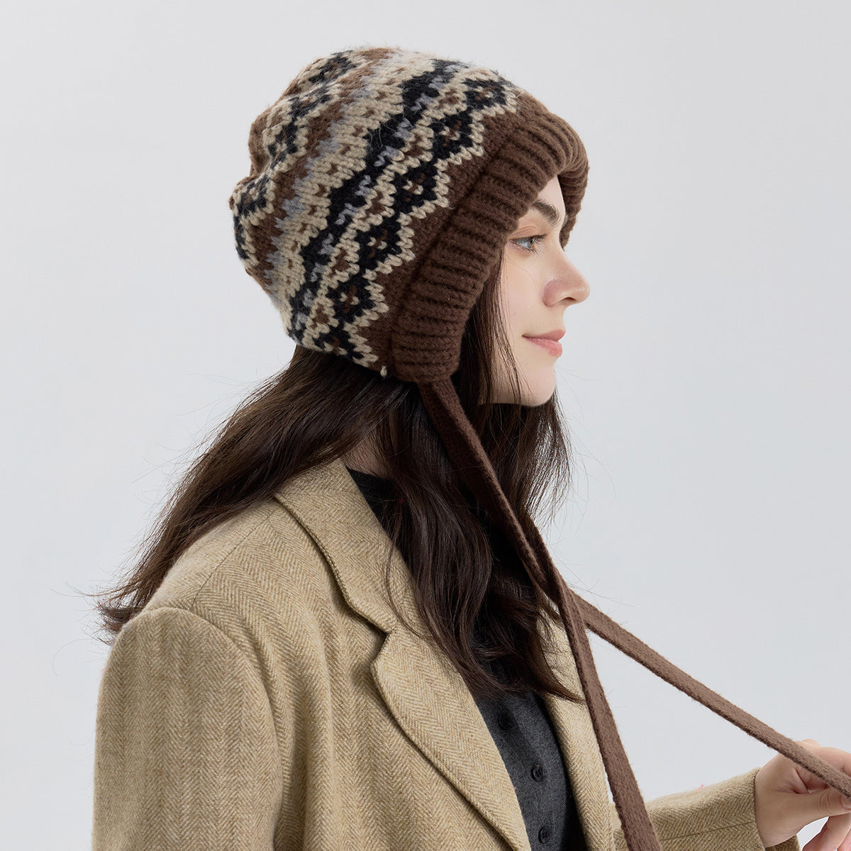 Fair Isle knit beanie with ribbed cuff and long tie strap, brown and black pattern