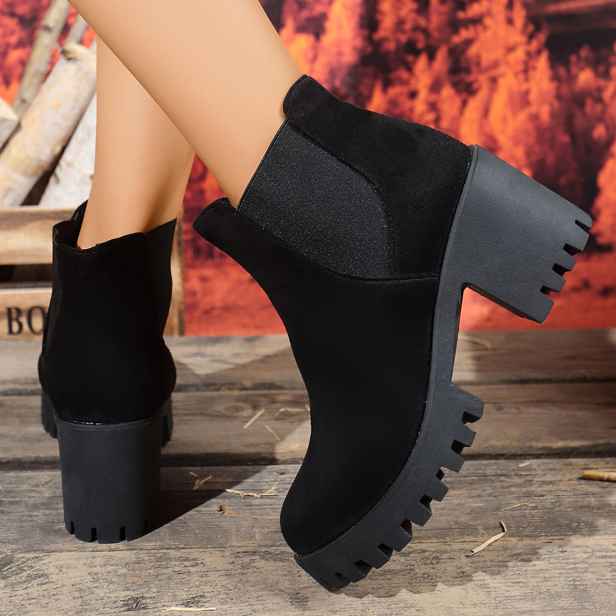 Black ankle boots with thick block heel, elastic gore, and rugged tread soles