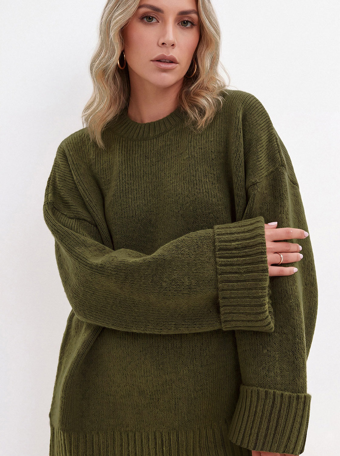 Close view of the military green sweater's knit texture and wide ribbed cuffs
