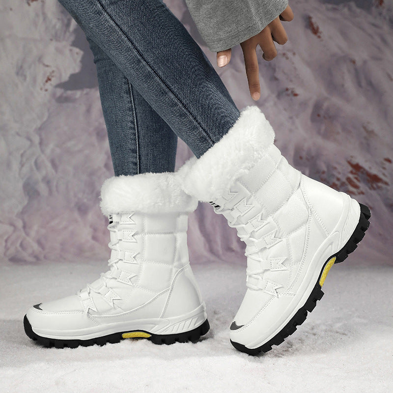 Women’s white mid-calf snow boots with fluffy top lining and lace-up straps, treaded outsole