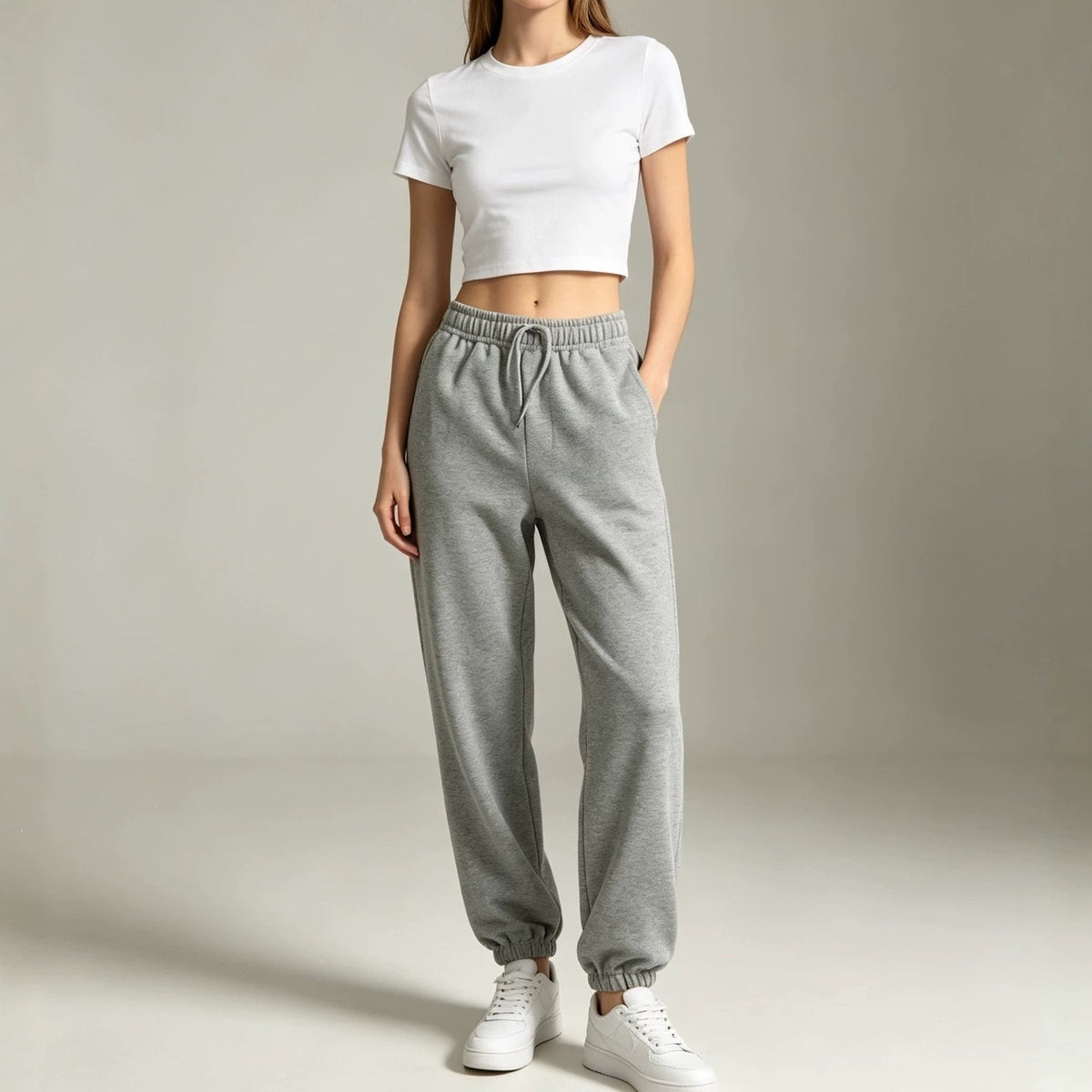 Gray fleece jogger sweatpants with elastic waistband and cuffed ankle cuffs