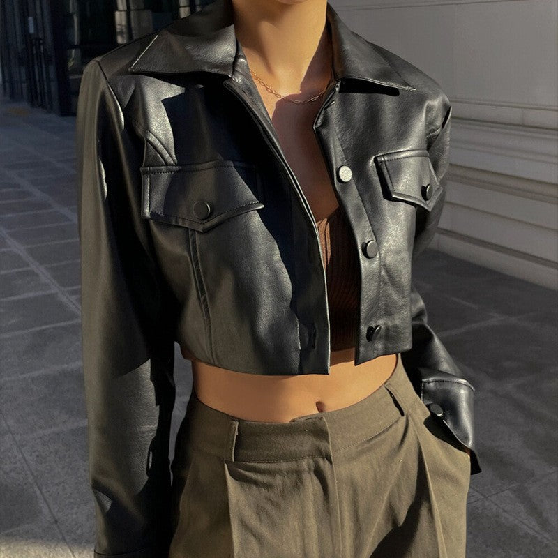Black cropped biker leather jacket with lapel, button front, and flap pockets