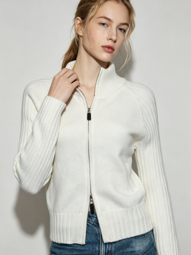 Women's white ribbed knit zip-up sweater jacket with stand collar and front zipper.