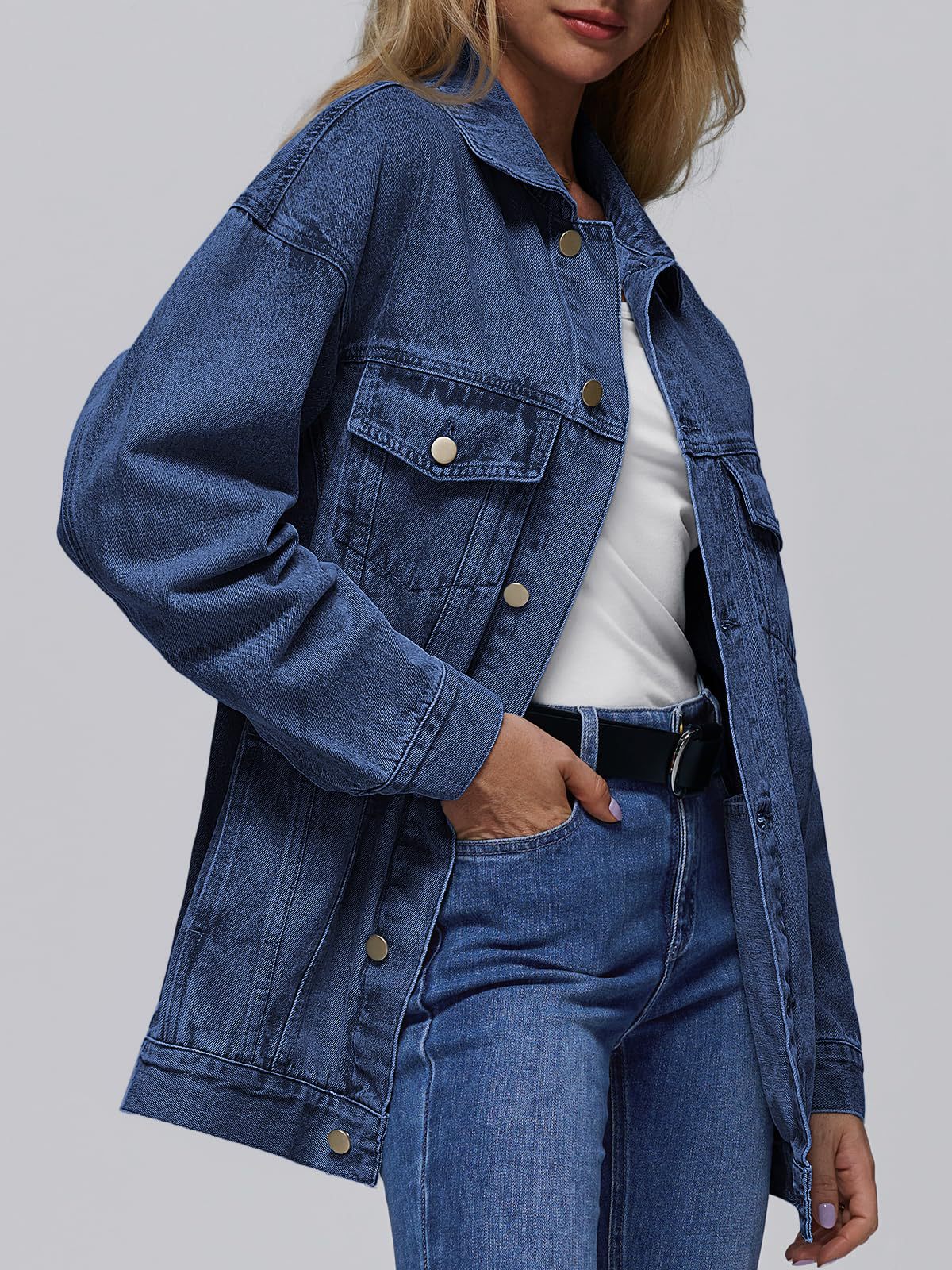 Dark blue denim jacket with button front, flap pockets, long sleeves and point collar