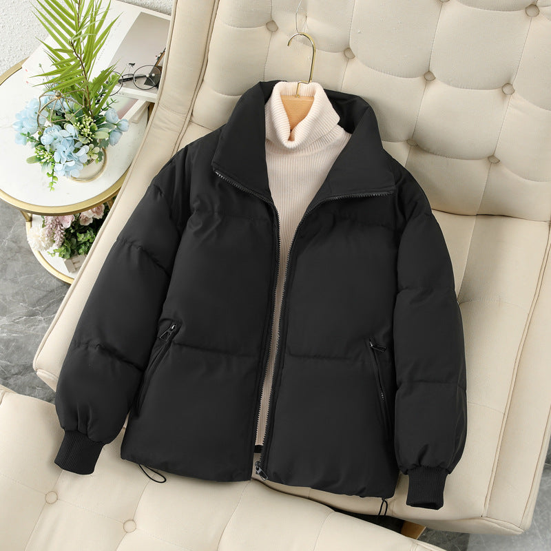 Short black puffer jacket with full-zip front, stand collar, and ribbed cuffs
