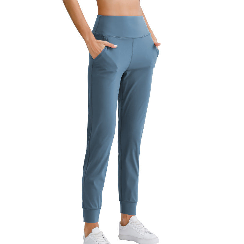 Women's blue ankle-length yoga pants with elastic waistband and tapered legs