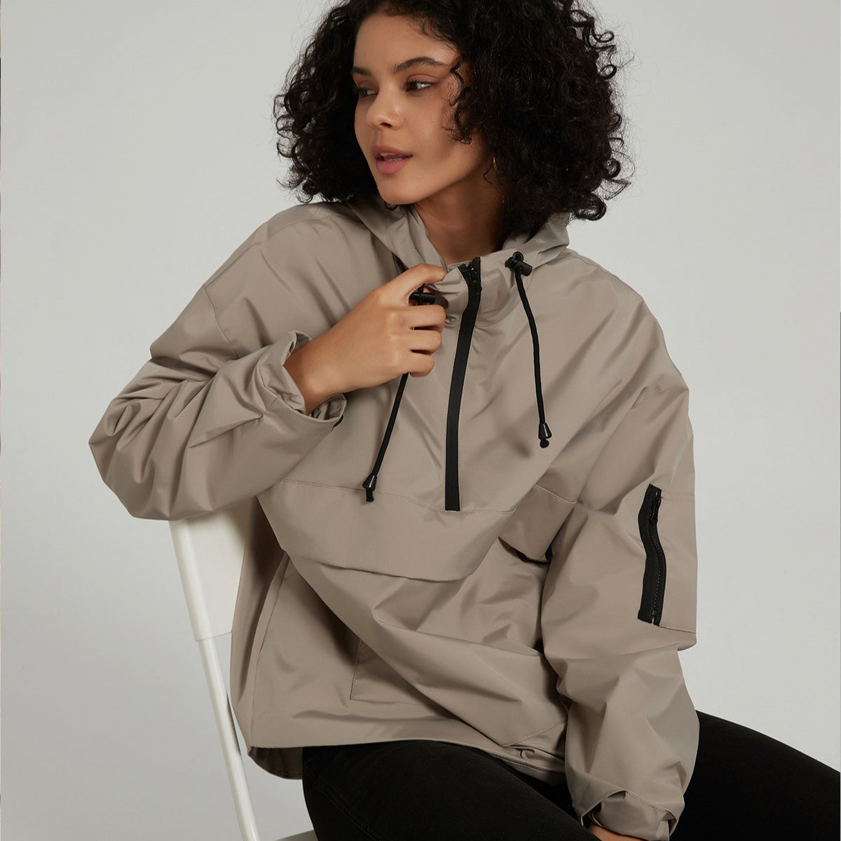 Women’s hooded windproof jacket in light gray with adjustable drawstring hood and zipper front