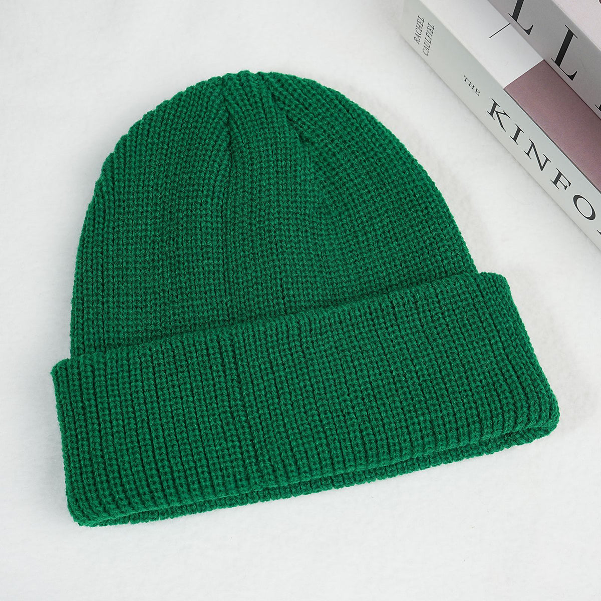 Green thick ribbed knit beanie hat with folded cuff.