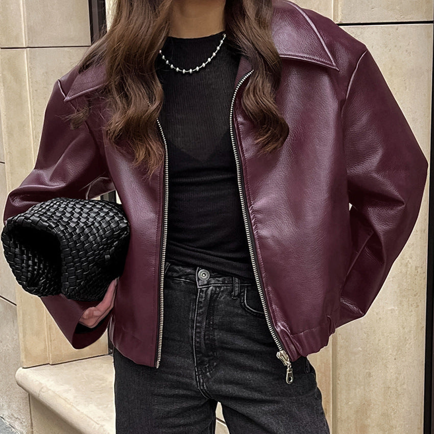 Women’s burgundy leather zip jacket with stand collar and silver zipper detail