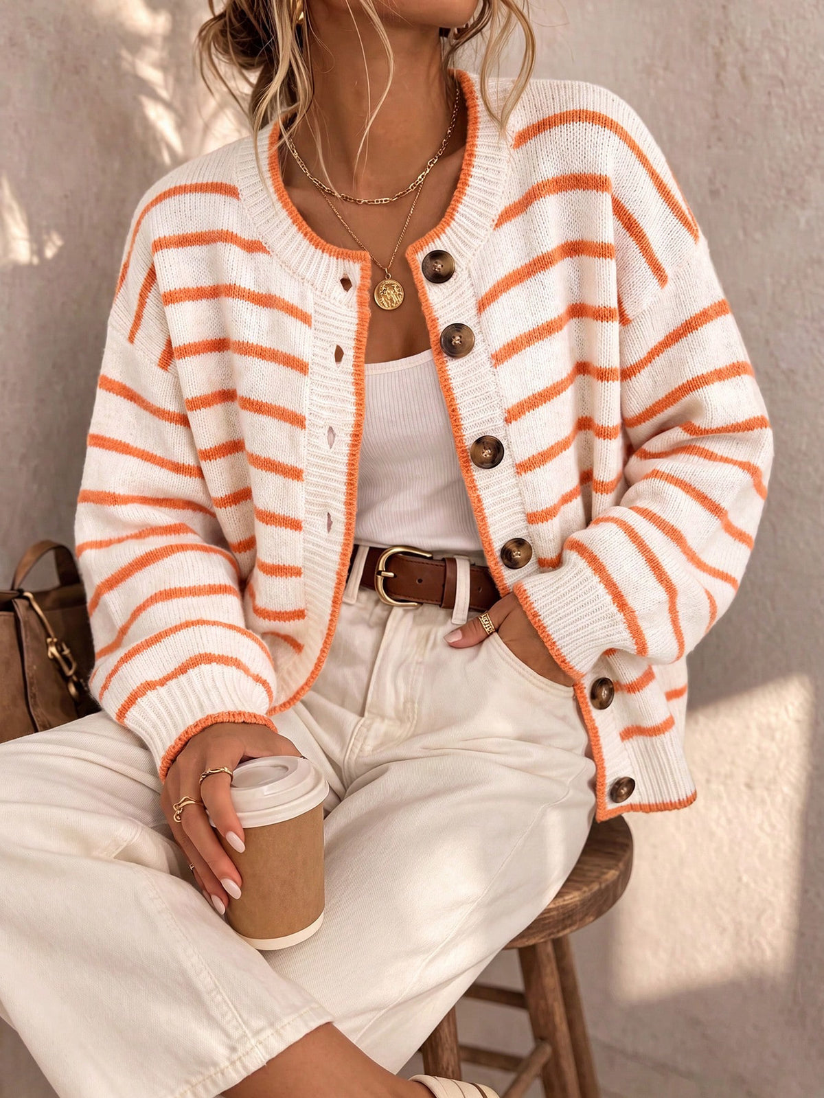Cream knit striped cardigan with orange stripes, button front and ribbed trim