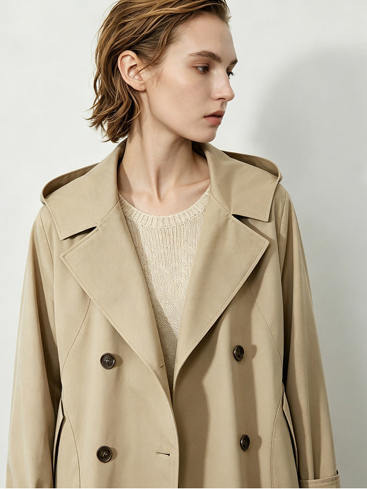 Close-up of khaki hooded trench coat lapels and dark buttons