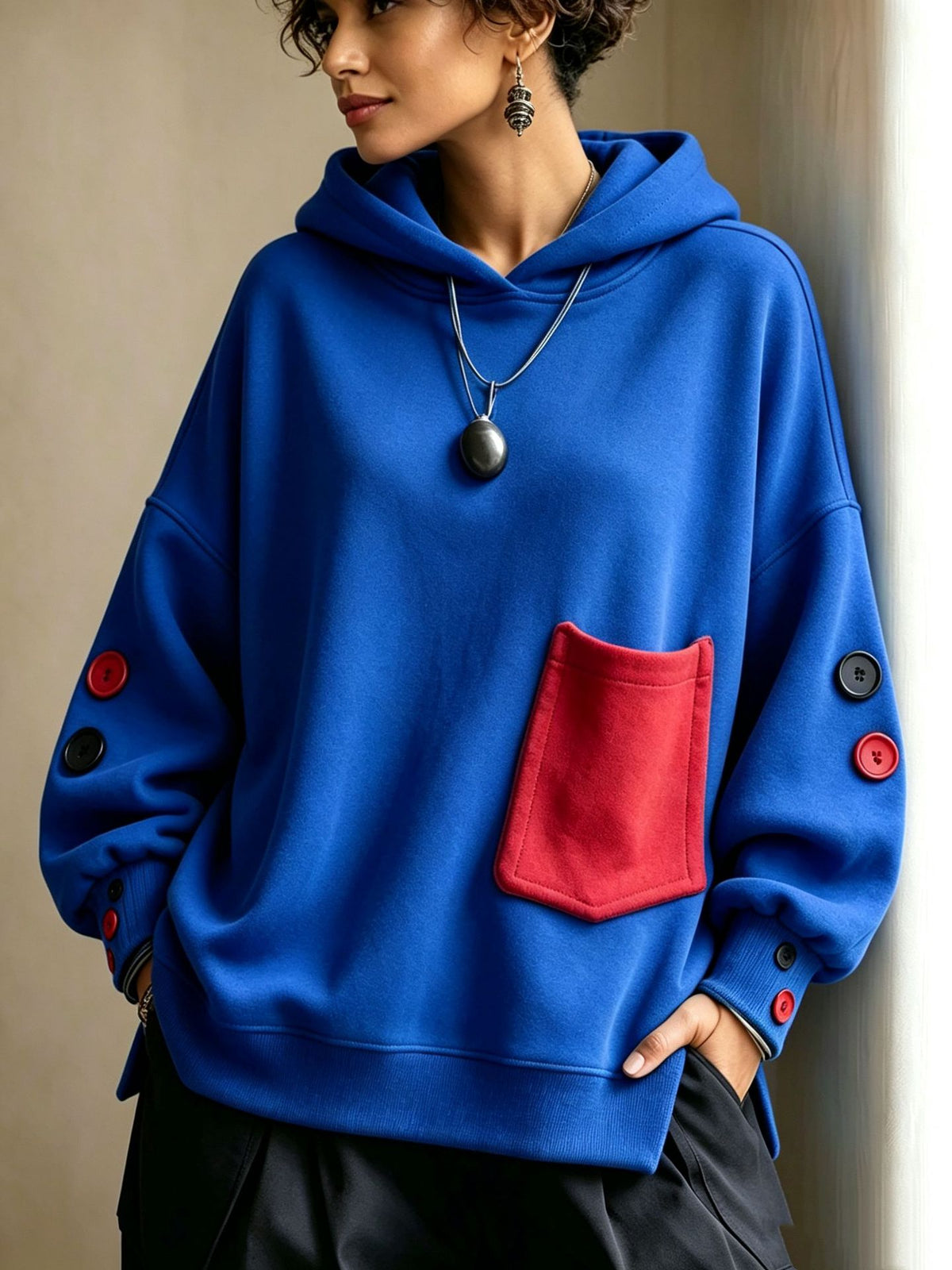 Blue pullover hoodie with front kangaroo pocket, hood drawstrings, buttoned sleeve cuffs
