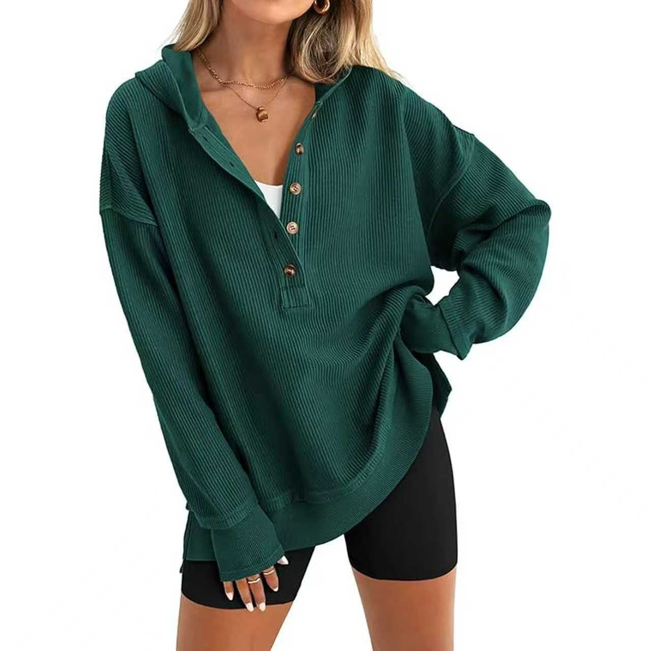 Dark green hooded henley sweatshirt detail: button placket and ribbed cuffs