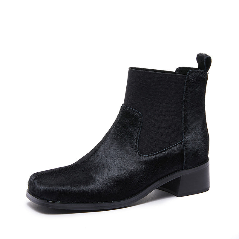 Women’s black leather Chelsea ankle boots with elastic gore and fuzzy cuff detail
