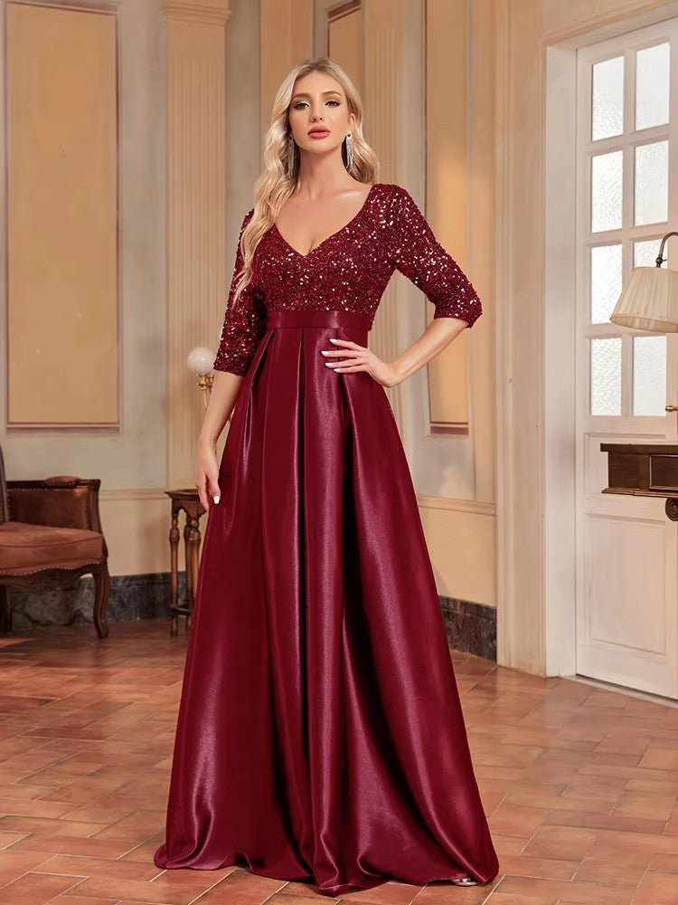 Deep red V-neck sequin evening dress with satin flared skirt, three-quarter sleeves