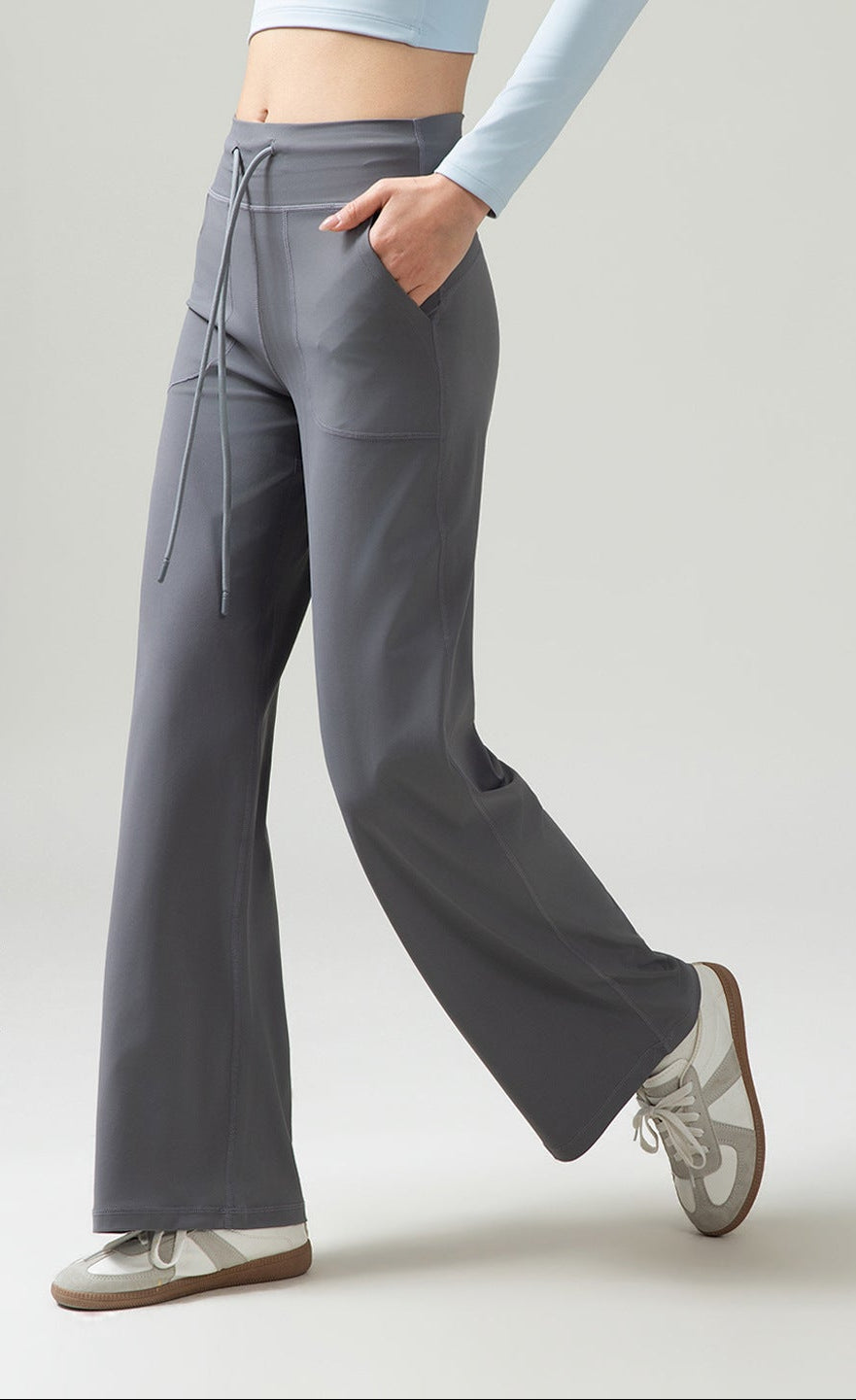 Women’s high-waisted wide-leg pants with drape, dark gray, drawstring ties at side.