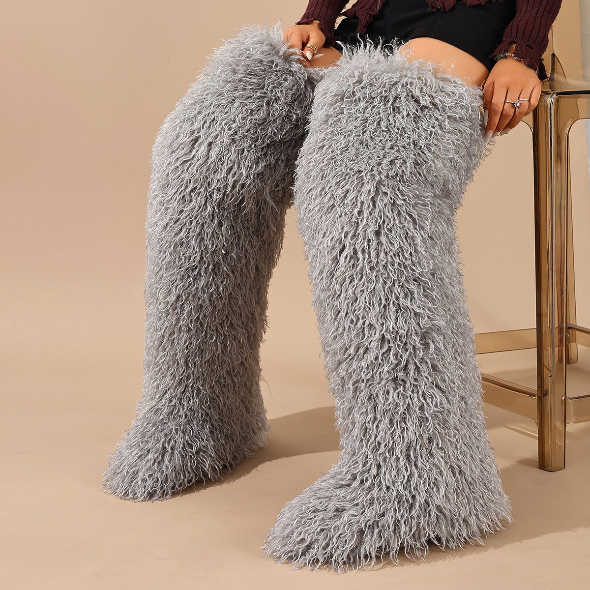 Light gray faux fur thigh-high boots with curly pile