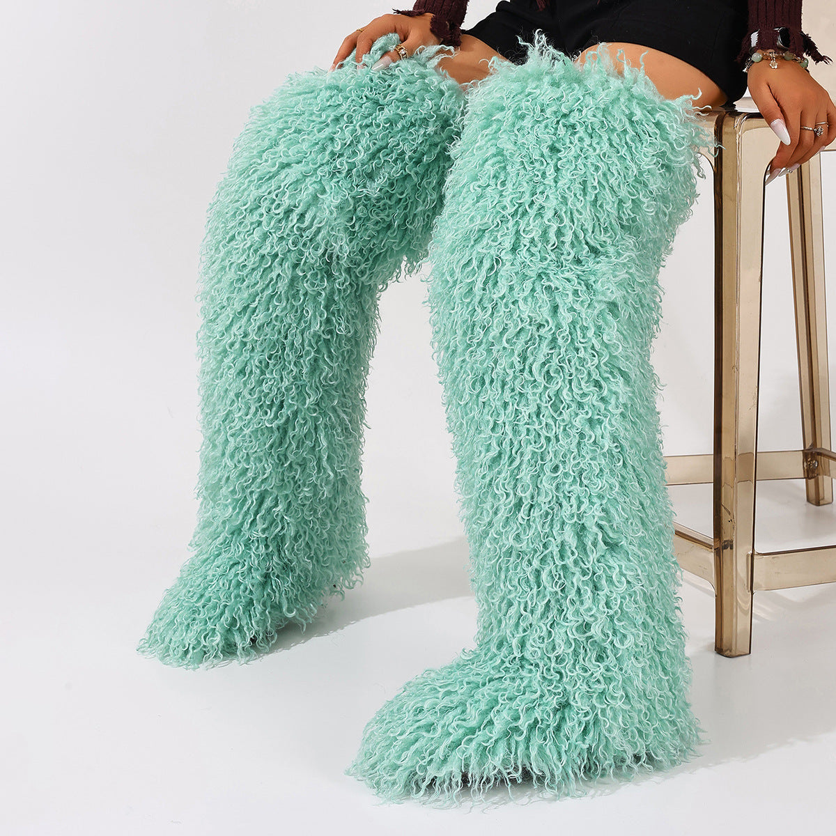 Mint green faux fur thigh-high boots with curly pile