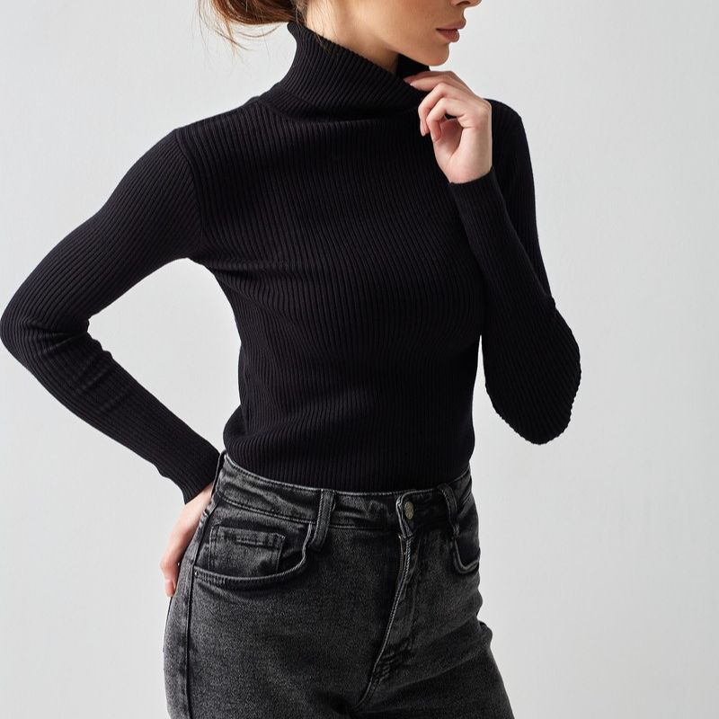 Black ribbed turtleneck knit sweater with long sleeves and high neckline