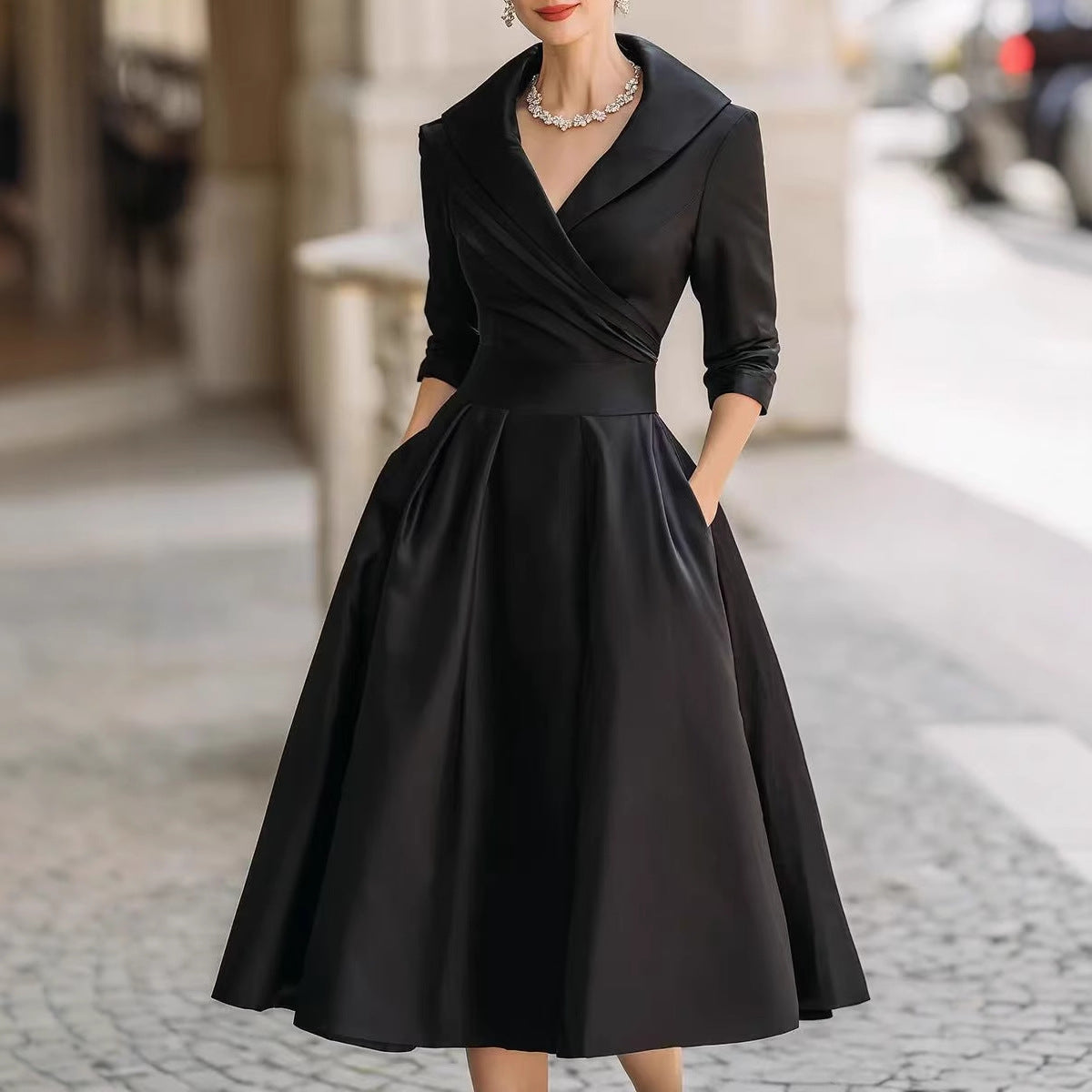 Women’s waist-cinching dress, black, long sleeves, V-neck, pleated A-line skirt.