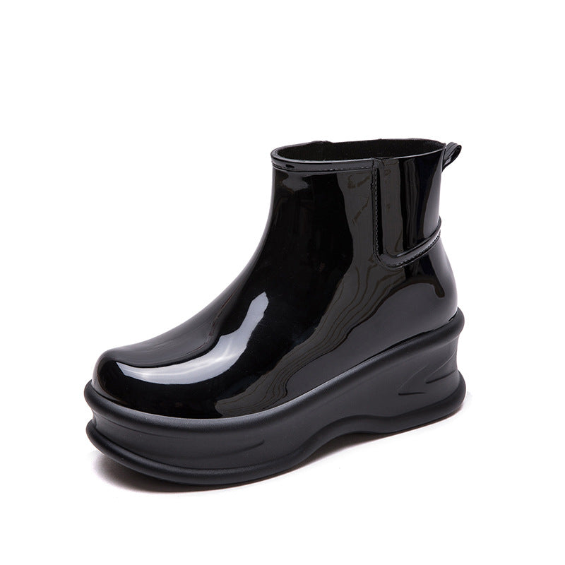 Black glossy mid-calf rain boot with side pull-tab and thick rubber platform sole